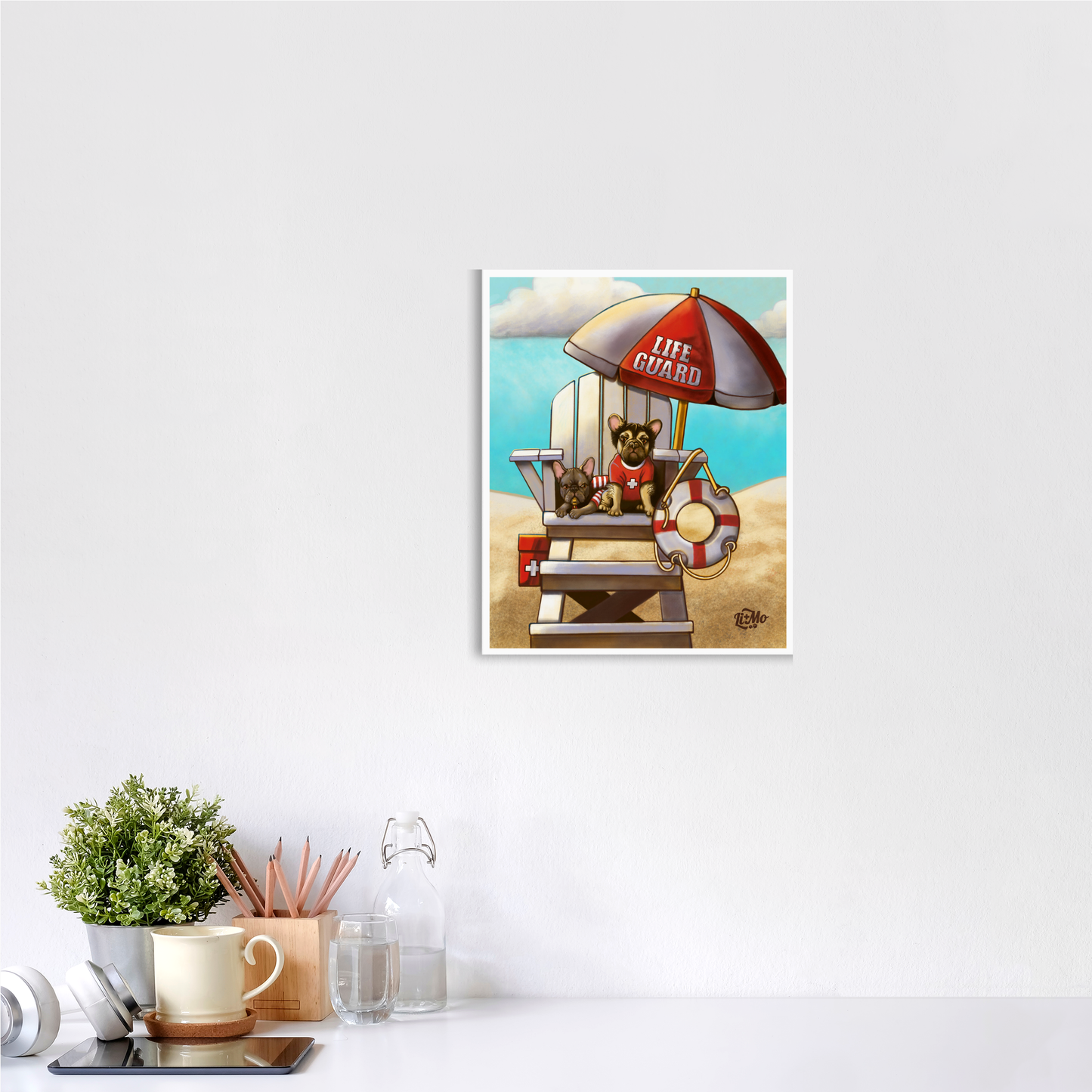 Caution Lifeguards on Duty giclée print, 11x14, framed on a wall above a white desk with a mug and plant. Illustration is displayed in a vertical format.