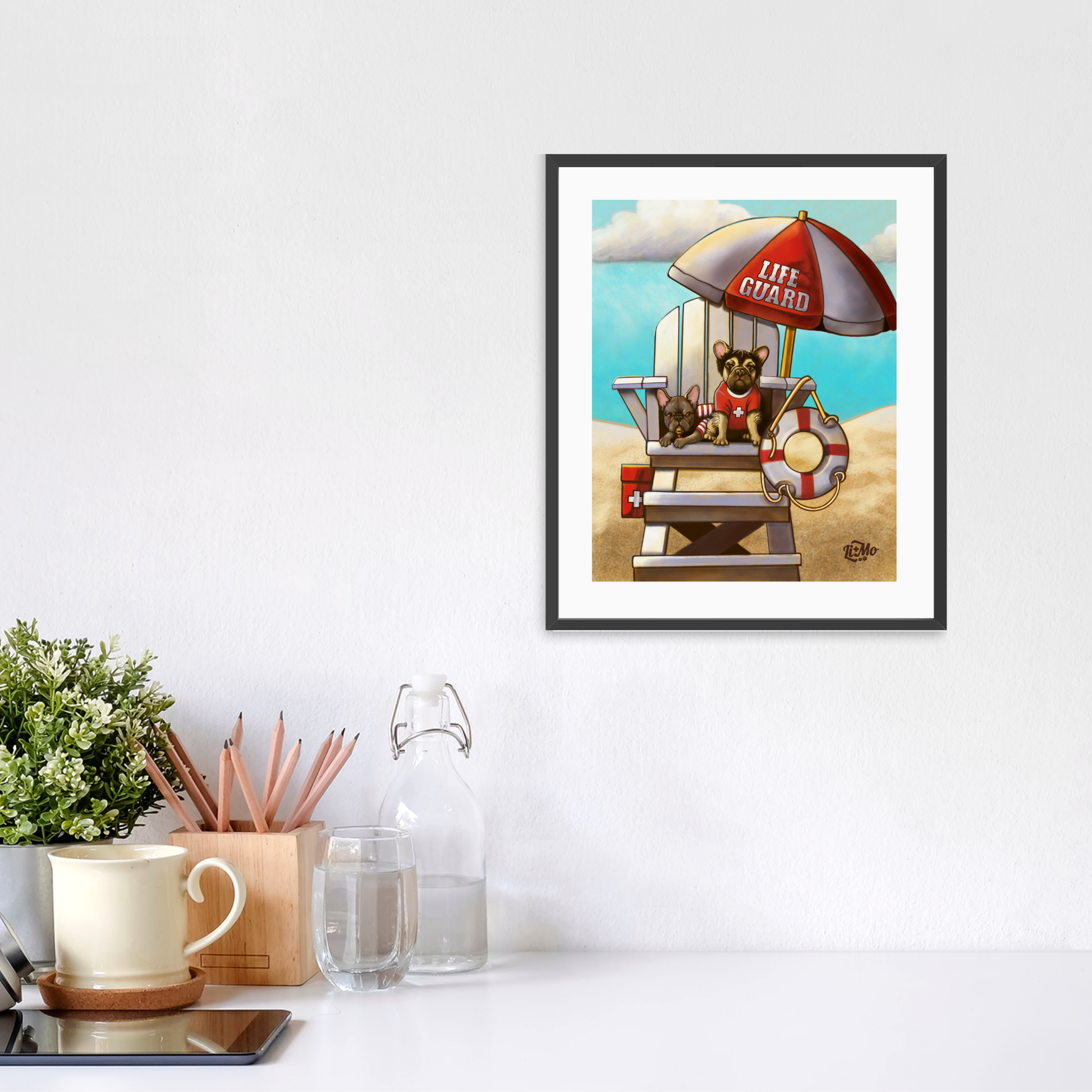 Caution Lifeguards on Duty vertical giclée print, 8x10, in a black frame, 11x13 approximate, on a wall above a white desk.