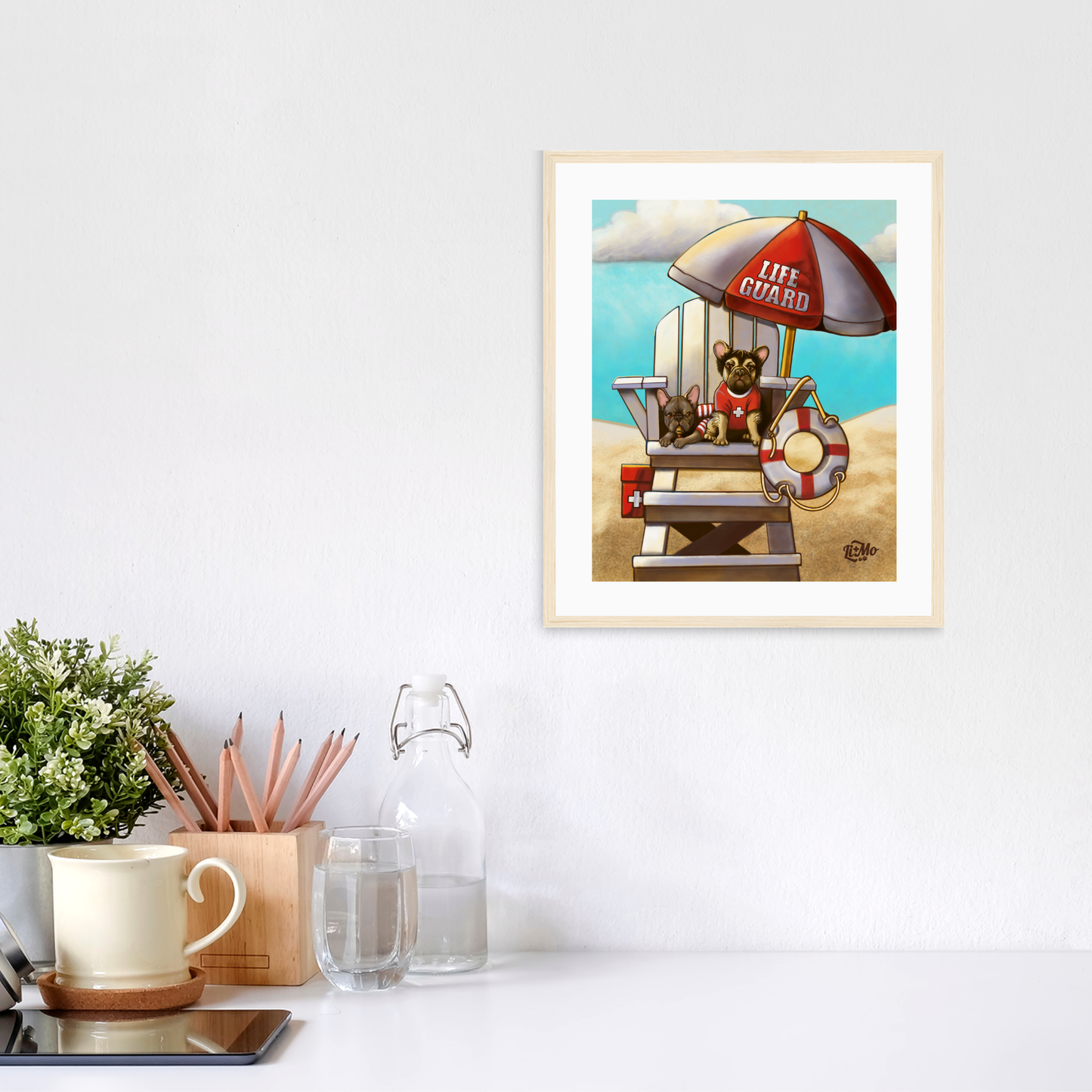 Caution Lifeguards on Duty vertical giclée print, 8x10, in a light colored natural wood frame, 11x13 approximate, on a wall above a white desk.